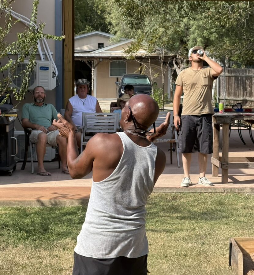 Men playing horseshoes at Revive Recovery Homes community event